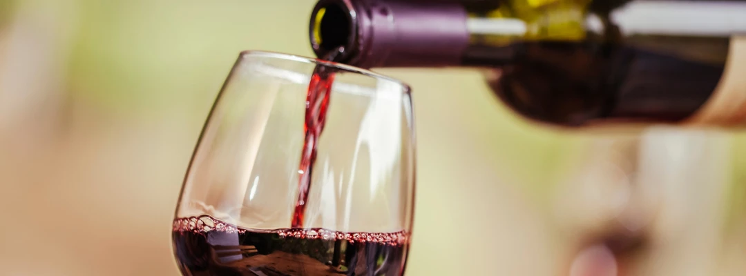 Red wine pouring into a glass.